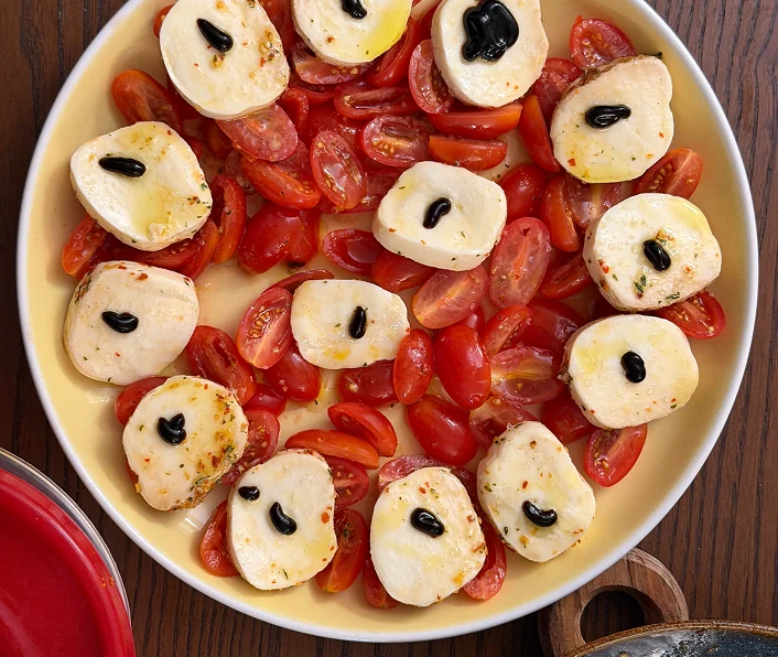 Caprese with tomatoes and olives.