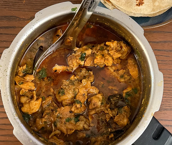 A chicken curry in a pot.