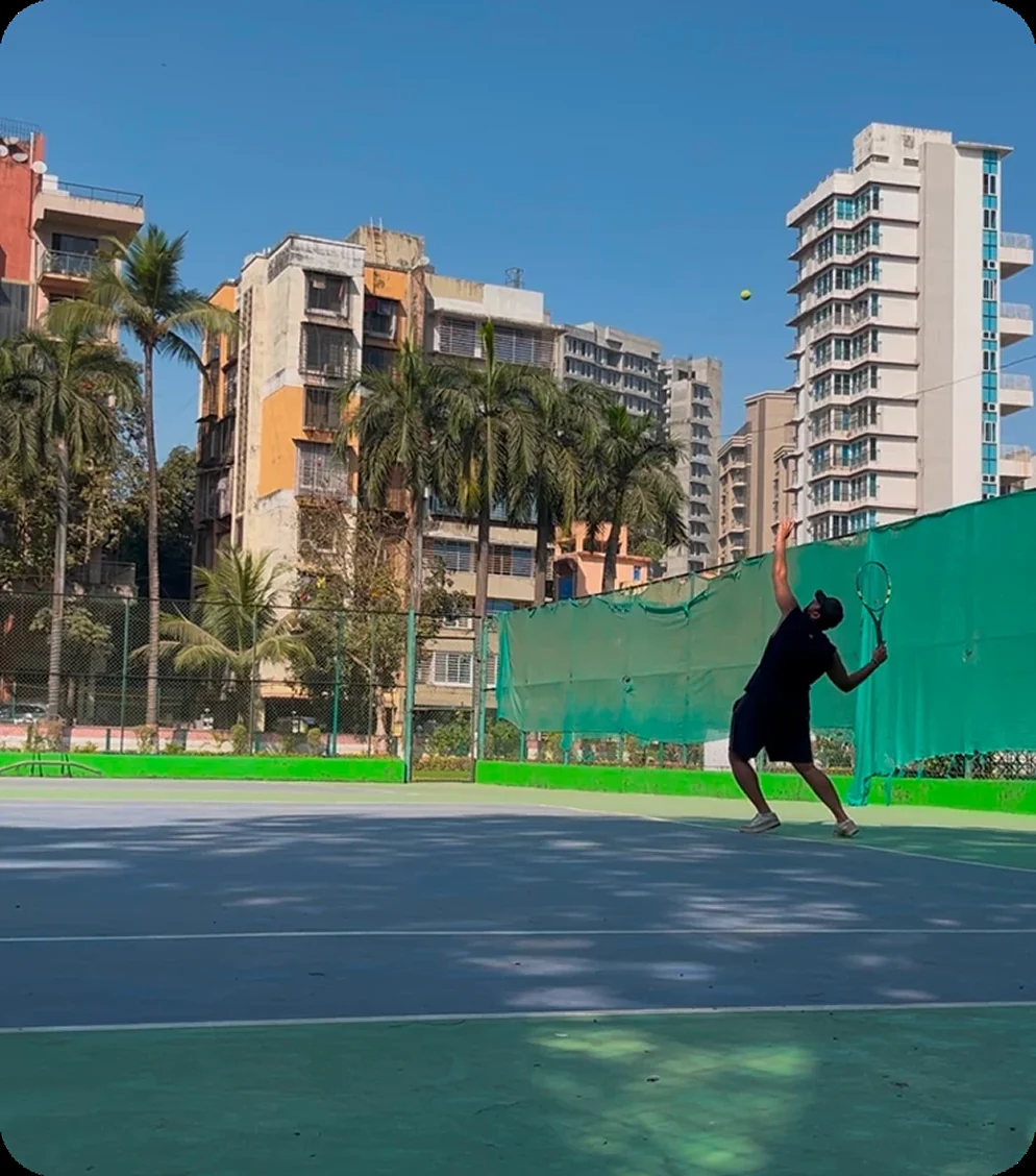 Serving on a tennis court in Mumbai.