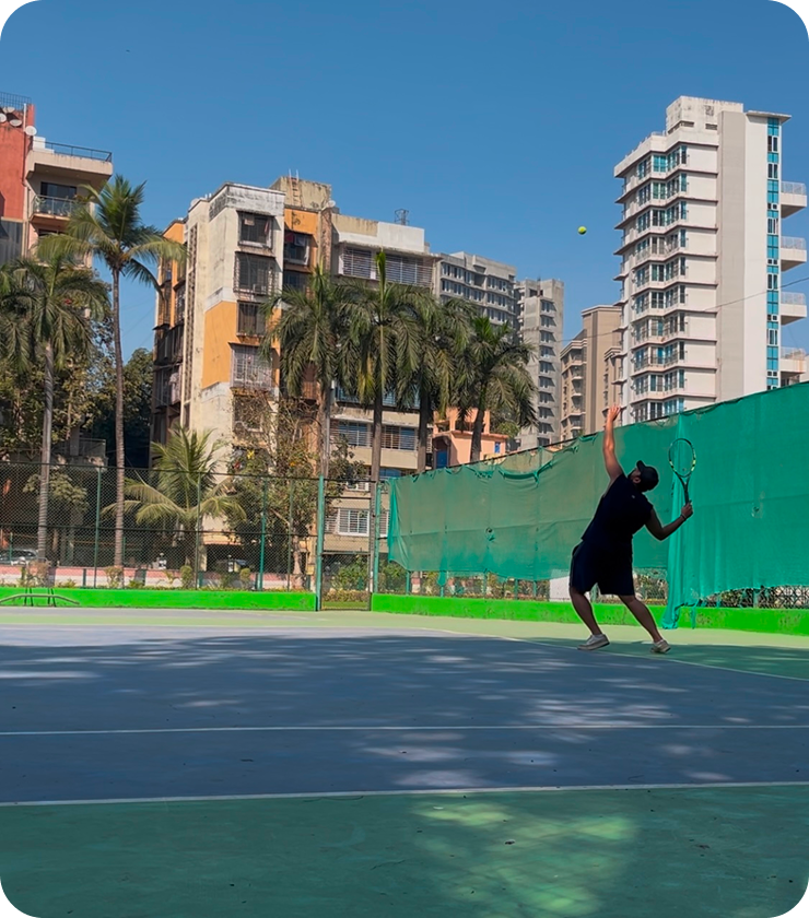 Sumeet playing lawn tennis on an outdoor court